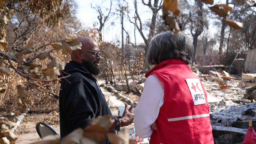 IFRC president Kate Forbes talks with a man who lost his home during the recent wildfires that tore through large portions of Los Angeles, California.