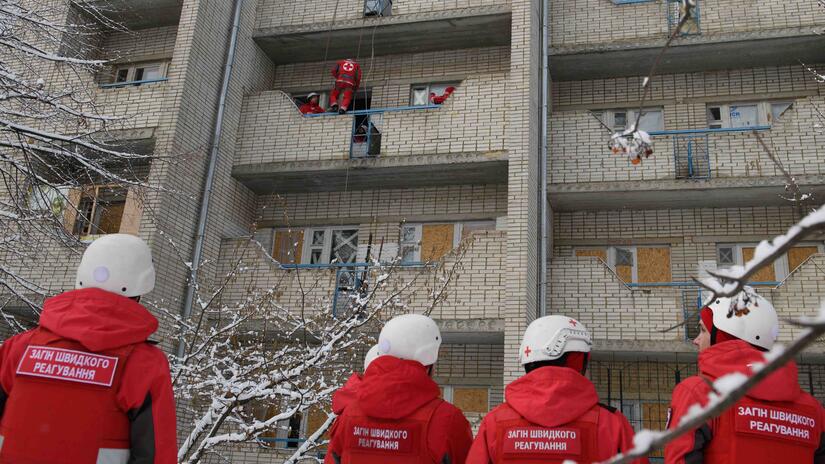 Members of a Ukrainian Red Cross emergency response unit taking part in a training exercise for evacuating people with limited mobility from the upper floors of apartment buildings.