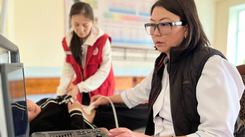Kyrgyzstan Red Crescent staff and volunteers team up with local health authorities to conduct ultrasounds on pupils at a school in Talas, Kyrgyzstan, to check for signs of parasitic diseases.
