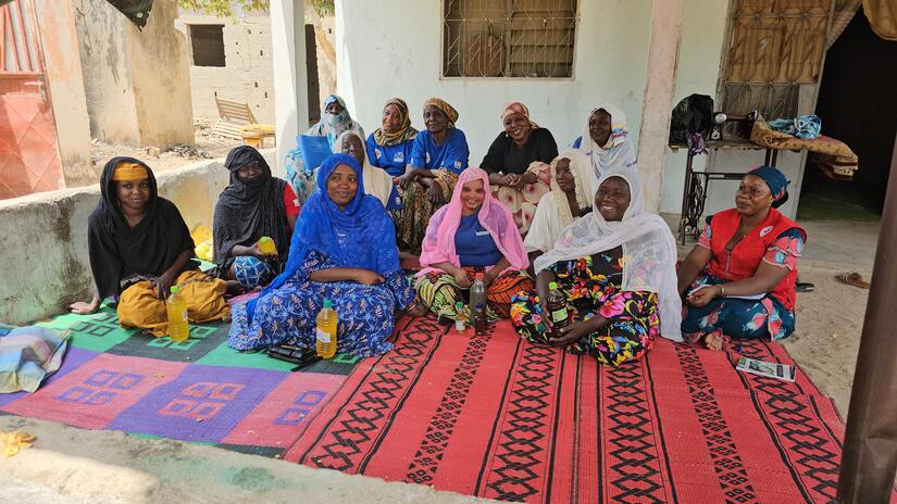 Members of the mothers’ club in Dougoï, in Cameroon’s Far North region, pose for a picture with the bottles of oil they’ve produce as part of an income generating activity.