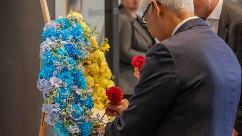 IFRC Secretary General Jagan Chapagain places a flower onto a wreath commemorating Red Cross and Red Crescent volunteers who lost their lives in the line of duty.
