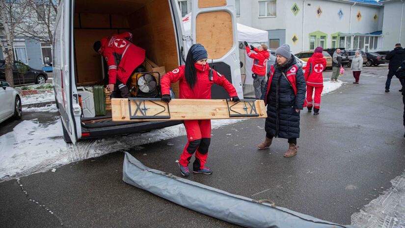 Ukrainian Red Cross teams set up a station where they will provide support to people impacted by large-scale power outages in Kyiv.
