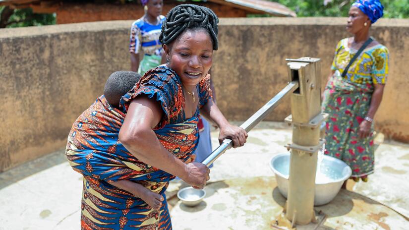  In the village of Lonfoloko in the west-African nation of Togo, a volunteer and member of the local Mothers Club pumps water from a well the group manages — part of the club's daily work keeping their families and communites healthy, clean and safe.