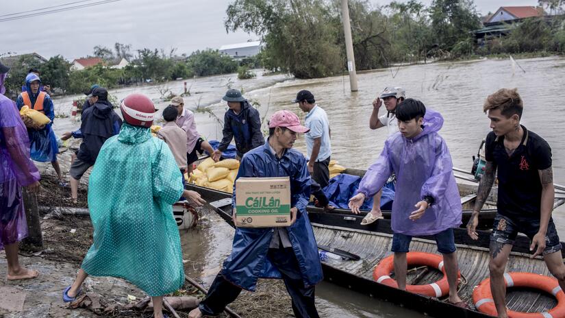 Local residents and volunteers deliver air packages to residents affected by heavy flood in Quang An Commune, Thua Thien Hue, Vietnam, on Monday, October 20, 2020. Families in Quang An Commune have be
