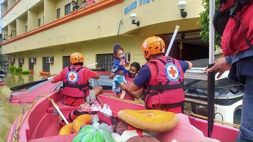Philippine Red Cross rescue people trapped in Cagayan Valley after flooding.