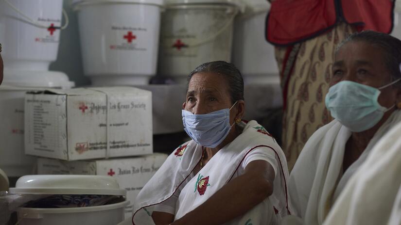 Day 2 Dhemaji, Assam, India. Beneficiaries at a relief distribution programme at the Red Cross office in Dhemaji, Assam in September 2020. As flood waters were receding, Dhemaji was hit by a fresh wav