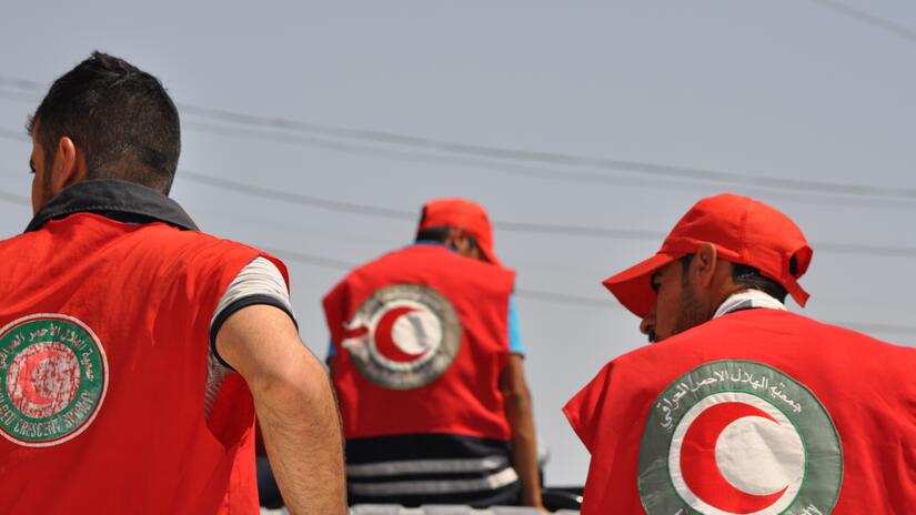 Iraqi Red Crescent volunteers deliver aid to families in Sinjar, where thousands of people have fled to escape the violence in Iraq.