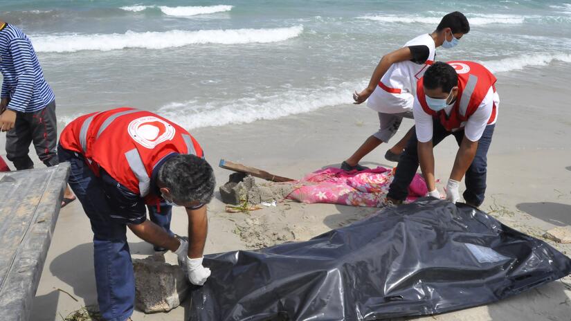 The dead body management team at the Libyan Red Crescent Society retrieving a body of a migrant who drowned when a boat carrying hundreds of people capsized off Libyan shores.
