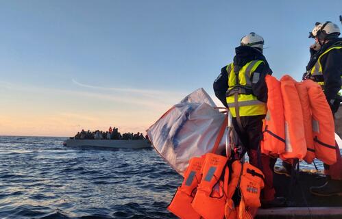 Search and rescue crews on board the Ocean Viking rescue ship approach a boat in distress in the Central Mediterranean in February 2022
