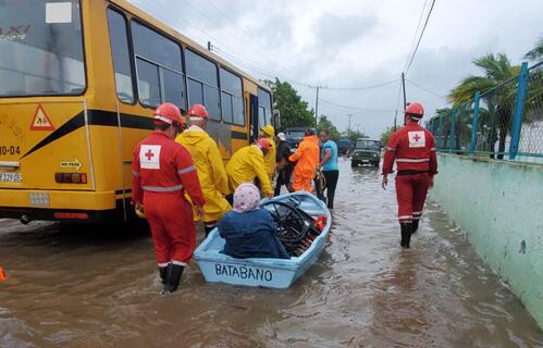 Cuban Red Cross volunteers transport an elderly lady via boat through flood waters caused by Hurricane Ian, which battered the region in late September 2022. Many National Societies in the region responded to help affected communities cope with the damage caused by the category 4 hurricane.