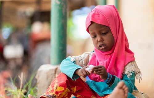 A young girl sits and plays quietly in Qaloàto village, Somaliland, where people are experiencing the worst drought in decades. The Somali Red Crescent Society together with its partners are doing what they can to support people struggling because of the drought. Many people have lost parts of, or all their livestock and are living in a very difficult situation.