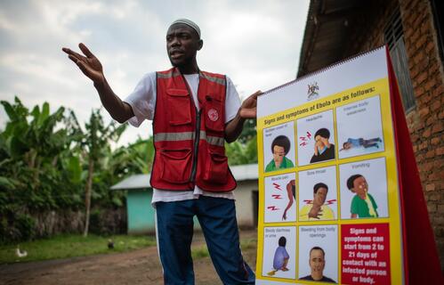 A Ugandan Red Cross volunteer speaks to communities about how to stay safe from the Ebola virus disease - responding to people's concerns and questions.