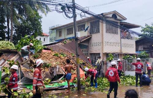 Myanmar Red Cross Society volunteers clean up an area of Thingankyun township which was struck by Cyclone Mocha in May 2023.