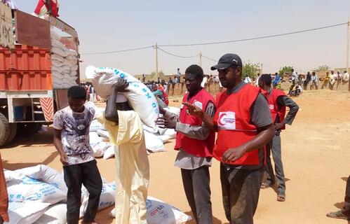 Sudanese Red Crescent Society volunteers distribute food to people in Khartoum who have been affected by the ongoing conflict in the country in late May 2023.