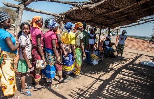 People line up for a food distribution following a prolonged period of drought in Mozambique.