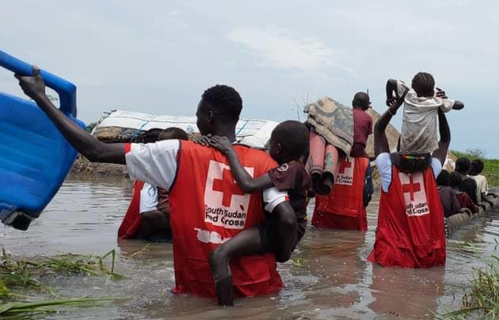 South Sudan Red Cross volunteers help people to safety during heavy flooding.