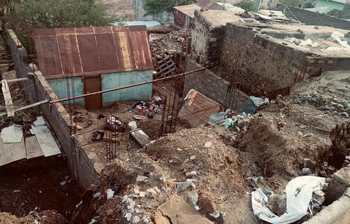 Sections of an urban neighborhoods washed away by severe flooding on the night of 10 August.