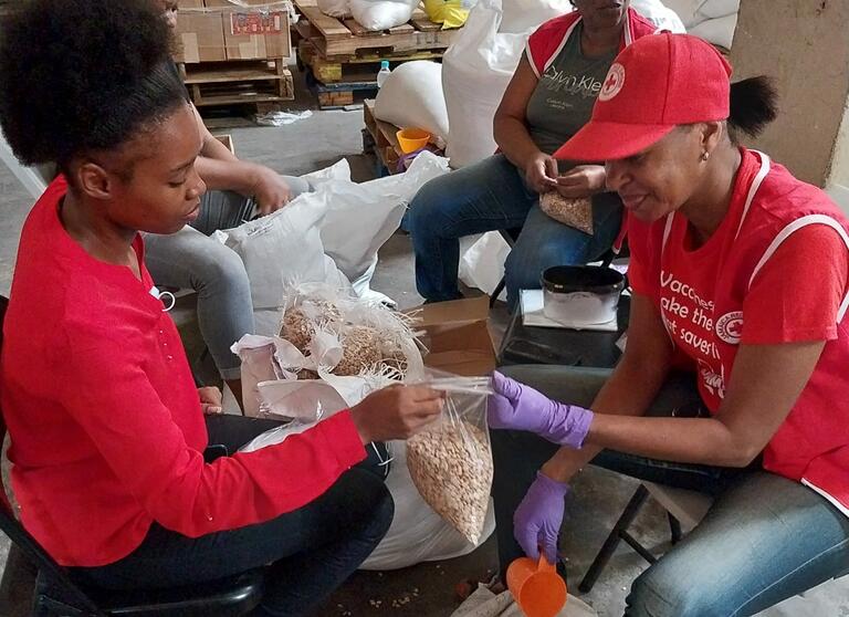 Jamaica Red Cross volunteers prepare relief supplies prior to Hurricane Beryl's landfall