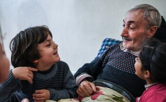 Said, a 66 year old Syrian man, is surrounded by his family in Ankara, Turkey. He receives cash assistance every month from the IFRC and Turkish Red Crescent, funded by the European Union, to help him cover his family's basic needs.