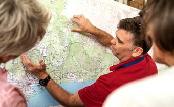 Australian Red Cross staff look at a map of Victoria to determine where people may need to be evacuated from due to the risk of bushfires