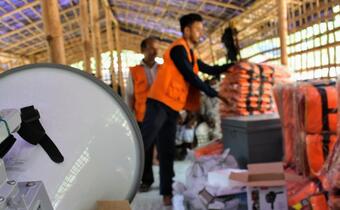 The Bangladesh Red Crescent Society distributes cyclone preparedness equipment to trained community volunteers as part of its cyclone preparedness programme in Cox's Bazar