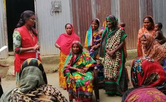 Volunteers from the Bangladesh Red Crescent Society consult a group of women affected by flooding in Tangail in 2019 to understand what assistance they need and how best to design programmes to support them