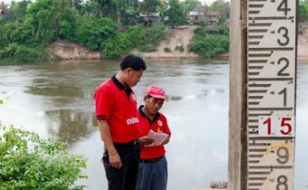 Members of a Village Disaster Protection Unit in Khammouane Province, Laos inspect a flood line metre during a disaster simulation testing their preparedness