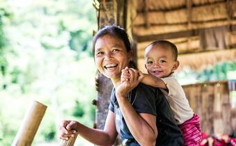 A mother and son smile in a small rural village in Laos in June 2017