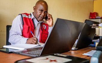 A volunteer with Eswatini Red Cross plans a cash distribution for over 2000 people in March 2020