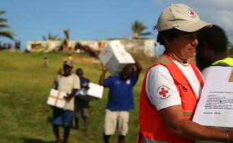 Red Cross volunteers distribute relief supplies in the northern part of Tanna island, Greenhill village, Vanuatu following Cyclone Pam in March 2015
