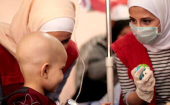 Volunteers with the Syrian Arab Red Crescent visit children who have been diagnosed with cancer at Aleppo University Hospital to boost their morale and hand out gifts during the month of ramadan