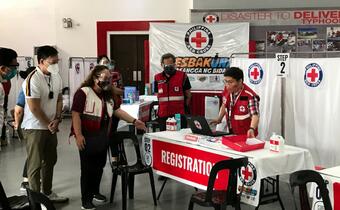 Volunteers with the Philippine Red Cross Society administer COVID-19 vaccines in a temporary vaccine facility in March 2021