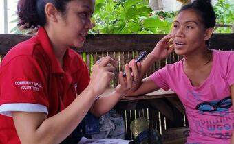 A Philippine Red Cross community health volunteer in Tacloban is one of the first trainees to use a mobile phone for community health data entry following Typhoon Haiyan in 2014.