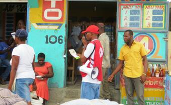 A volunteer with the Haiti Red Cross shares health messages in his community on how people can stay safe from the Chikungunya virus