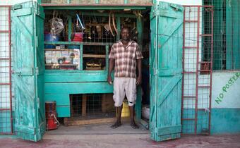 A local business owner in Turkana county, Kenya stands in front of his shop. His business suffered due to drought in the area in 2017 and he received cash assistance from the Kenyan Red Cross to help support his livelihood.