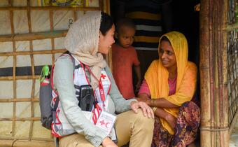 A health delegate from the Japanese Red Cross speaks to a woman living in Cox's Bazar refugee camp Bangladesh