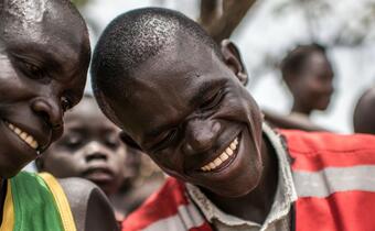 A volunteer with the Ugandan Red Cross talks with South Sudanese refugees about the dangers of cholera and how to avoid it in Bidi Bidi refugee camp in northern Uganda.