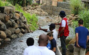 Delegates from IFRC, ECHO, UNDP, St. Vincent & The Grenadines Red Cross, and French Red Cross visit a riverside community as a part of a risk reduction field visit.