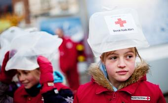 Children in Copenhagen are supported by the Danish Red Cross to carry water to the Copenhagen Bella Centre where climate negotiations were taking place as a tribute to the women and girls who have to walk kilometres every day just to access clean water