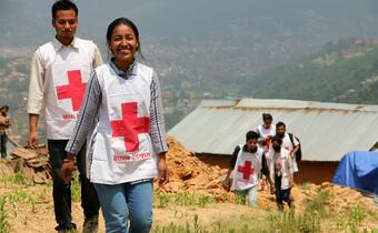 A team of young Nepal Red Cross Society volunteers delivers tents and tarpaulins to households in the remote village of Khalchok following the earthquake in 2015