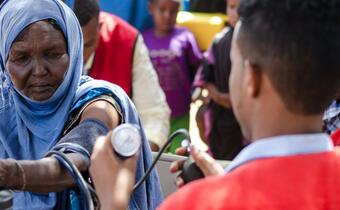 A nurse from the Somali Red Crescent Society performs a health check up on a woman from a rural community in Somaliland during the drought in 2017