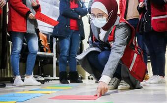 Female volunteers with the Syrian Arab Red Crescent plan humanitarian activities in March 2021 to respond to COVID-19
