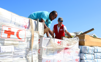 Red Cross delegates unload relief items during a distribution at Marsh Harbour port, the Bahamas following Hurricane Dorian