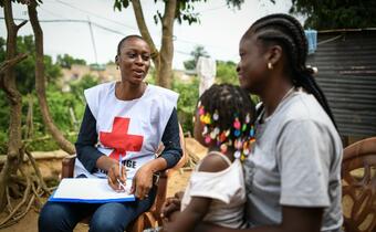 Dr Anita Mtongo speaks to a woman about her health needs at a local health centre in Binza Meteo in the Democratic Republic of the Congo as part of a volunteering shift with the DRC Red Cross