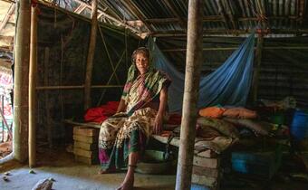 A woman in Cox's Bazar, Bangladesh sits inside her home where she lives  and receives support from the Bangladesh Red Crescent Society having fled Rakhine state, Myanmar in 2017