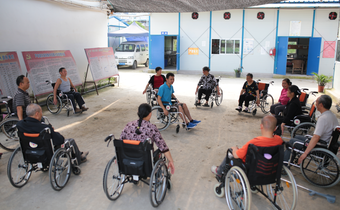 A Red Cross Society of China volunteer runs a wheelchair shadowboxing session with members of his community following the Sichuan Earthquake in 2013