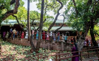 People in Mahabaleshwar, India wait in line to receive their COVID-19 vaccine at a rural hospital supported by the Indian Red Cross Society