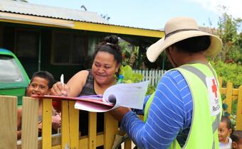 A family in Tonga receives relief items from the Tonga Red Cross following Tropical Cyclone Gita in 2018