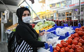 A Syrian woman living in Turkey purchases fresh fruit and vegetables during the COVID-19 pandemic with cash assistance received through the Emergency Social Safety Net project