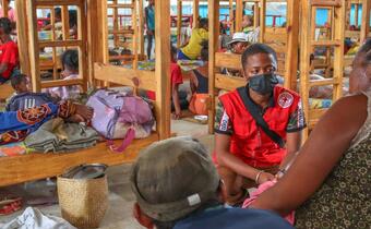Malagasy Red Cross volunteers comfort people sheltering in an accommodation centre in Atsinanana region after Cyclone Batsirai hit the country in February 2022